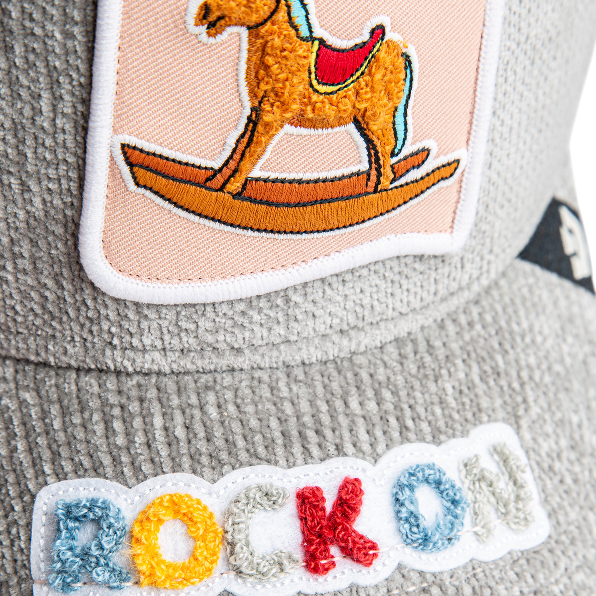 Grey mesh back corduroy hat featuring rocking horse design