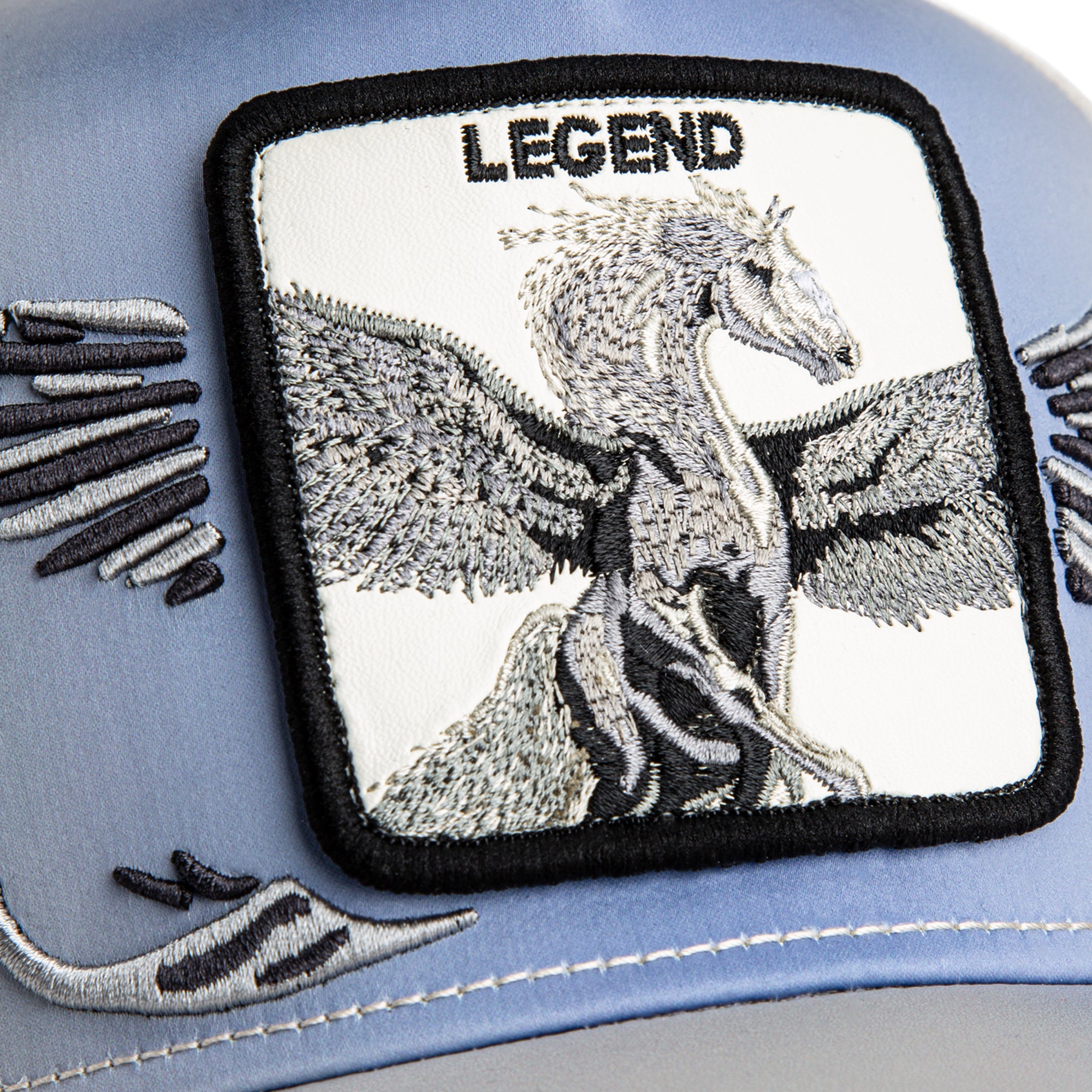 Embroidered patch of a dragon with 'LEGEND' text on a blue background
