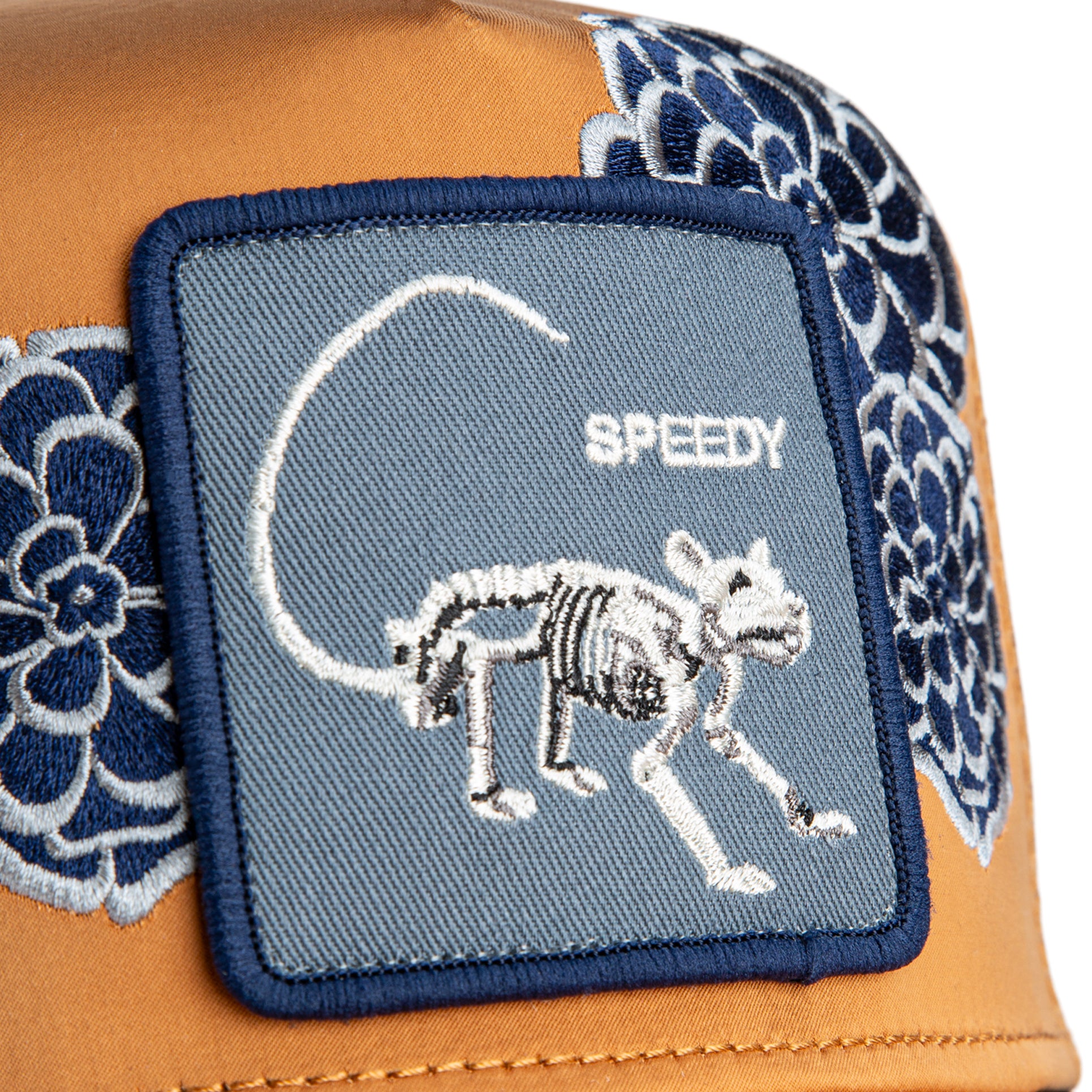 Tan and blue embroidered animal patch trucker hat