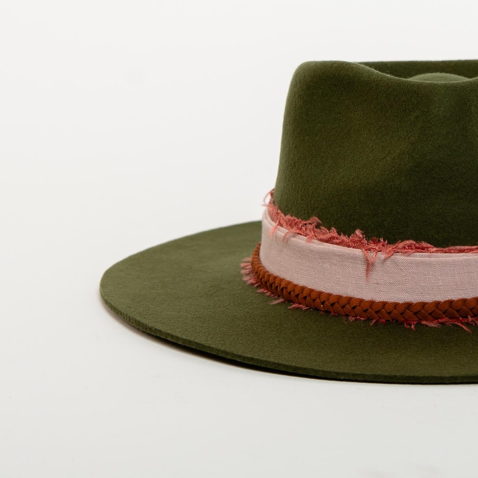 Green fedora hat with a decorative band on a white background