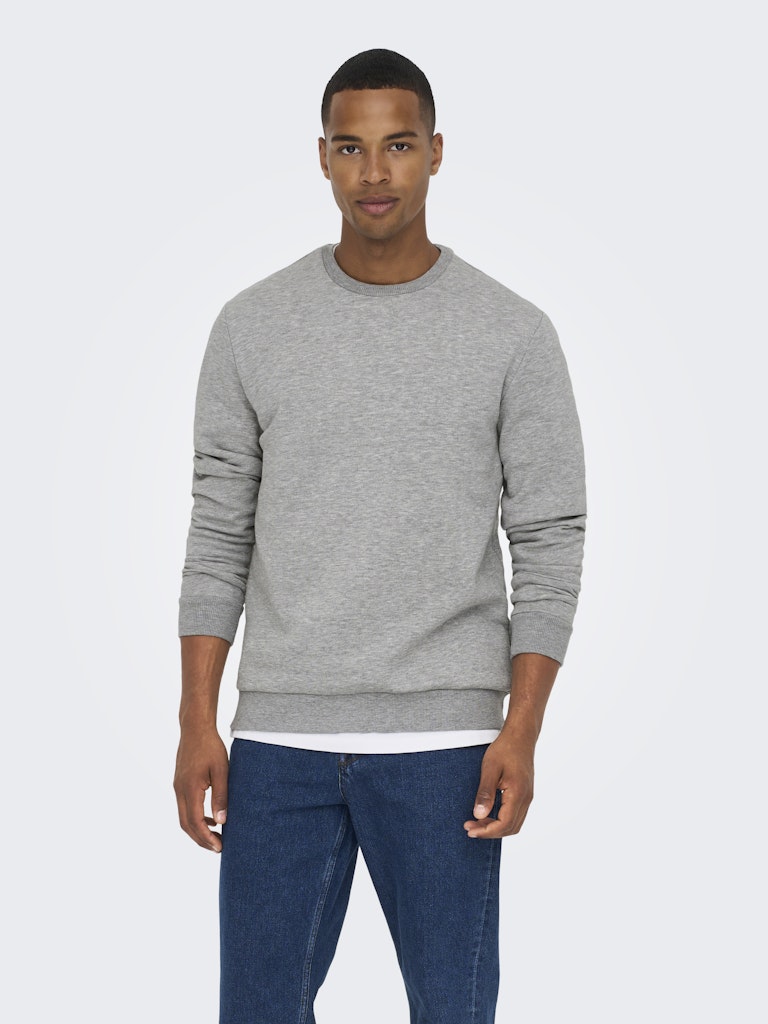 Man wearing a gray sweater and blue jeans on a white background By Only & Sons