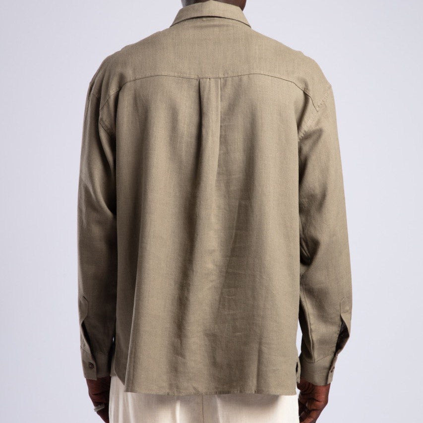 Man wearing a beige shirt and pants on a white background