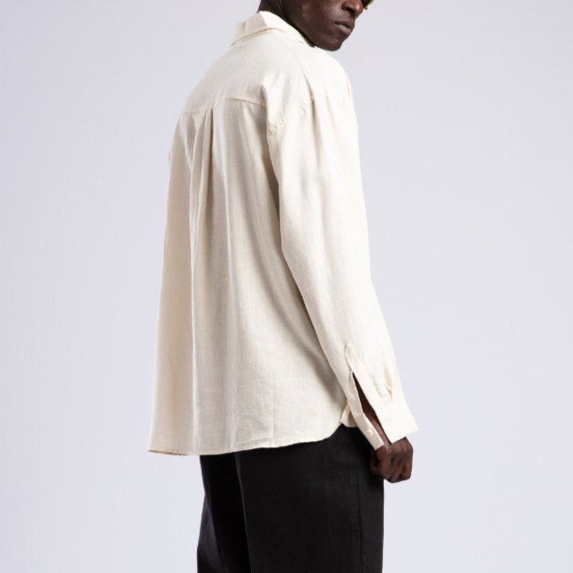 Man wearing a white shirt and black pants on a white background