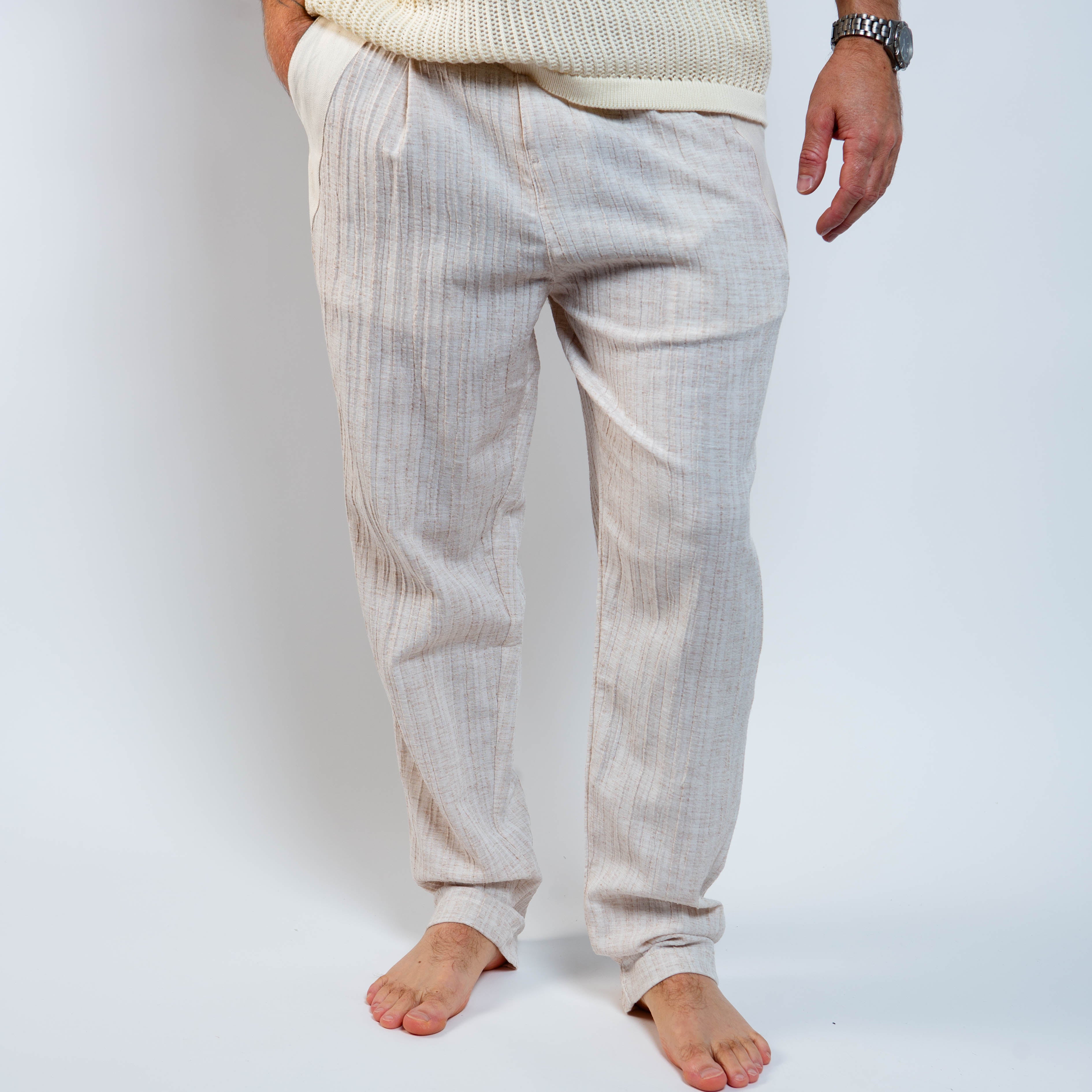 Light-colored pants worn by a person on a white background