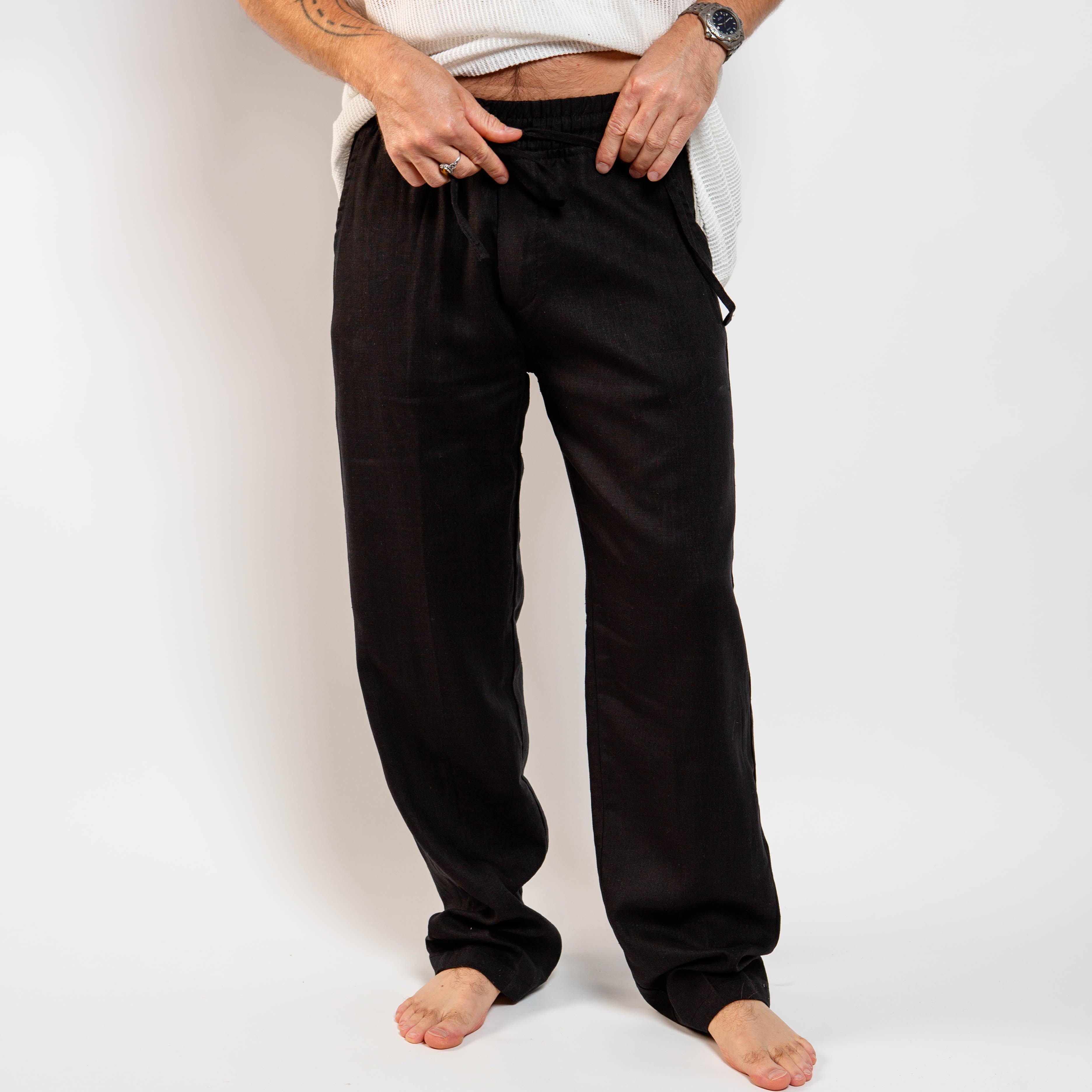 Person wearing black pants on a white background