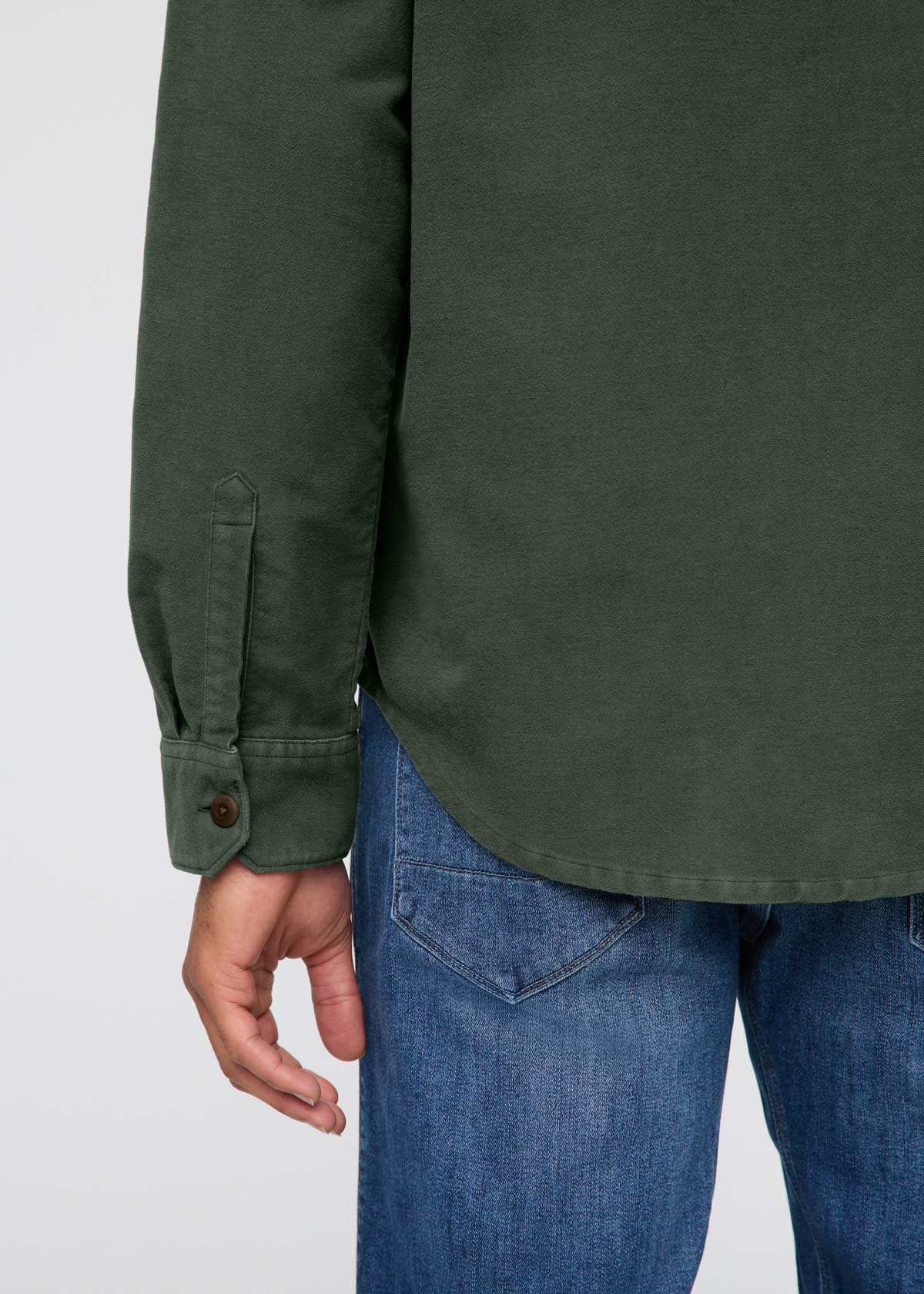 Green shirt and blue jeans on a white background By Duer Jeans