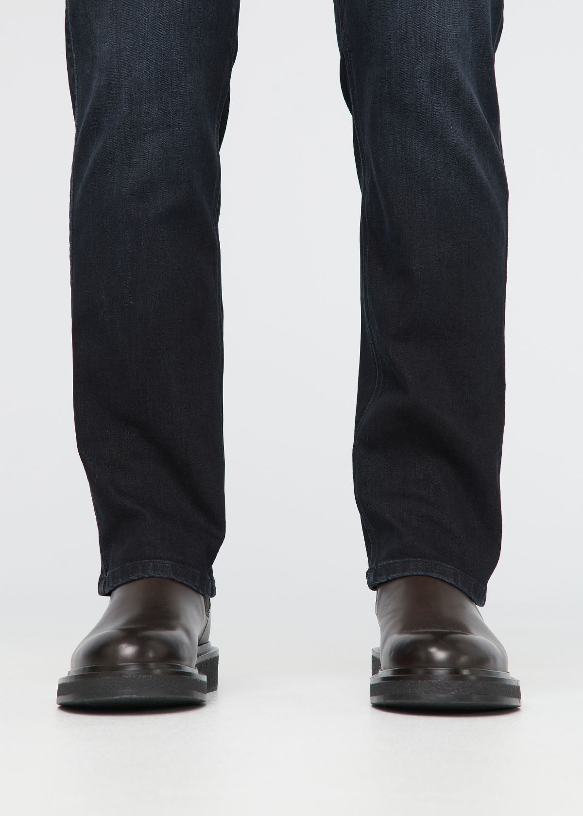 Black jeans worn by a person on a white background By Duer Jeans