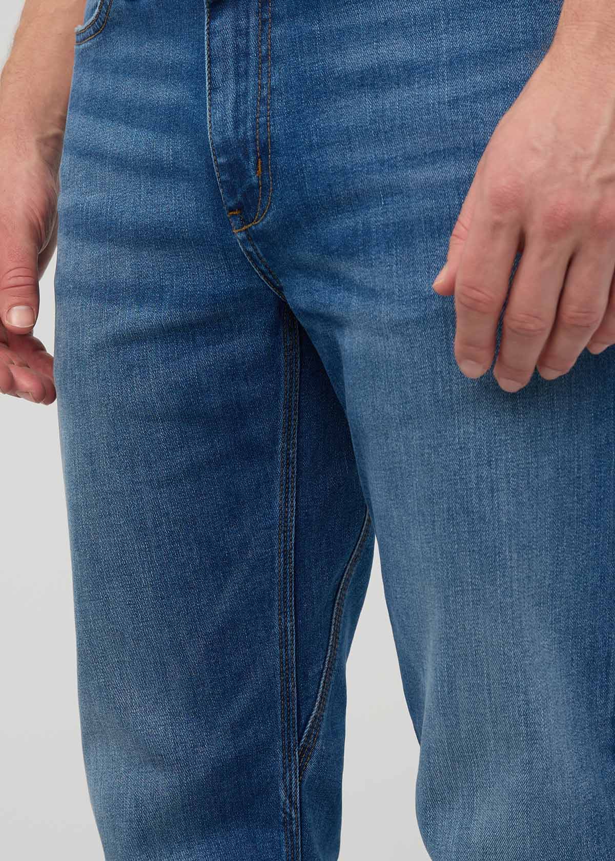 Close-up of blue jeans on a plain background By Duer Jeans