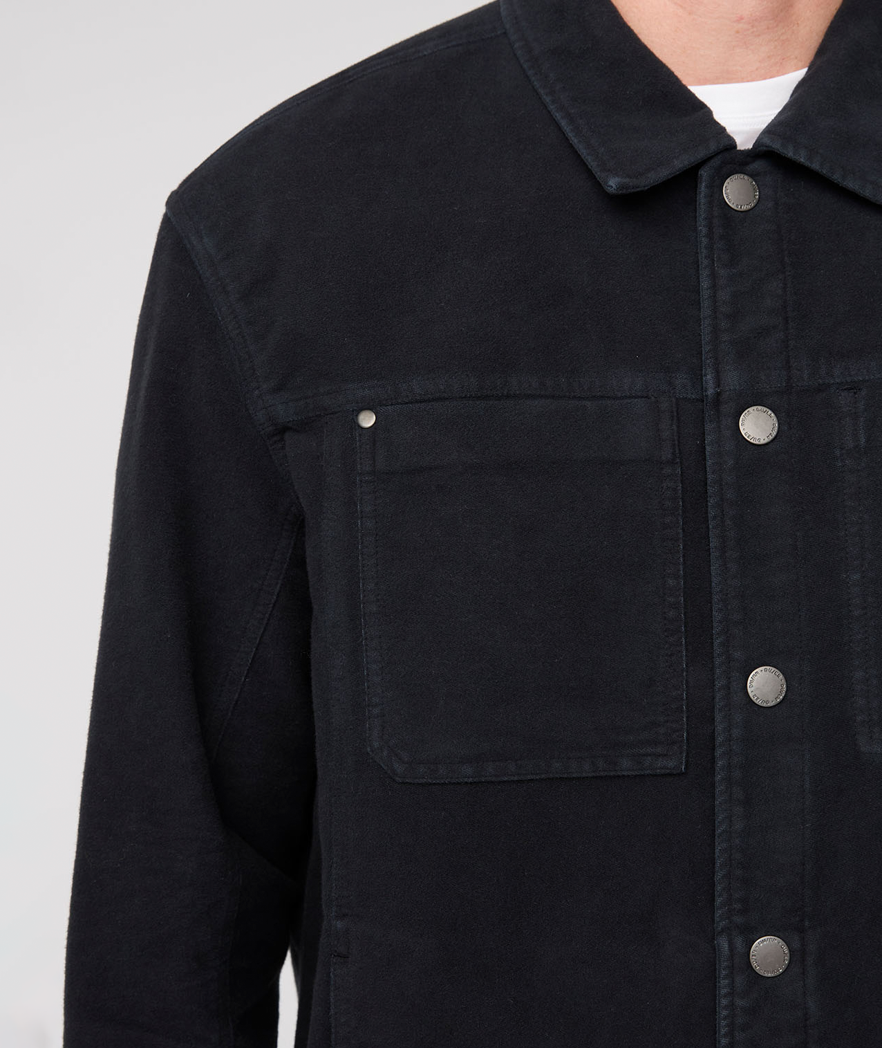 Black jacket with button details on a white background By Duer Jeans