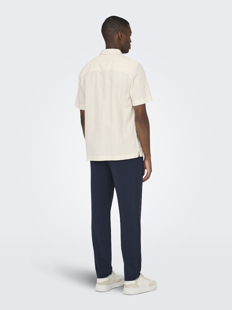 wilson white short sleeve textured cotton shirt back view model navy trousers