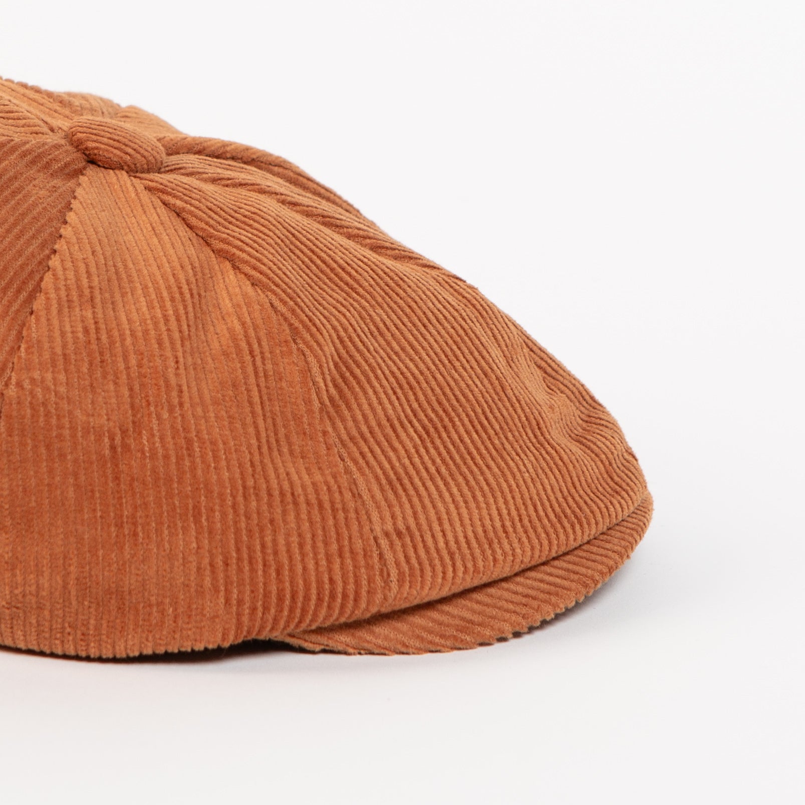 rust corduroy fabric detail on newsboy cap
