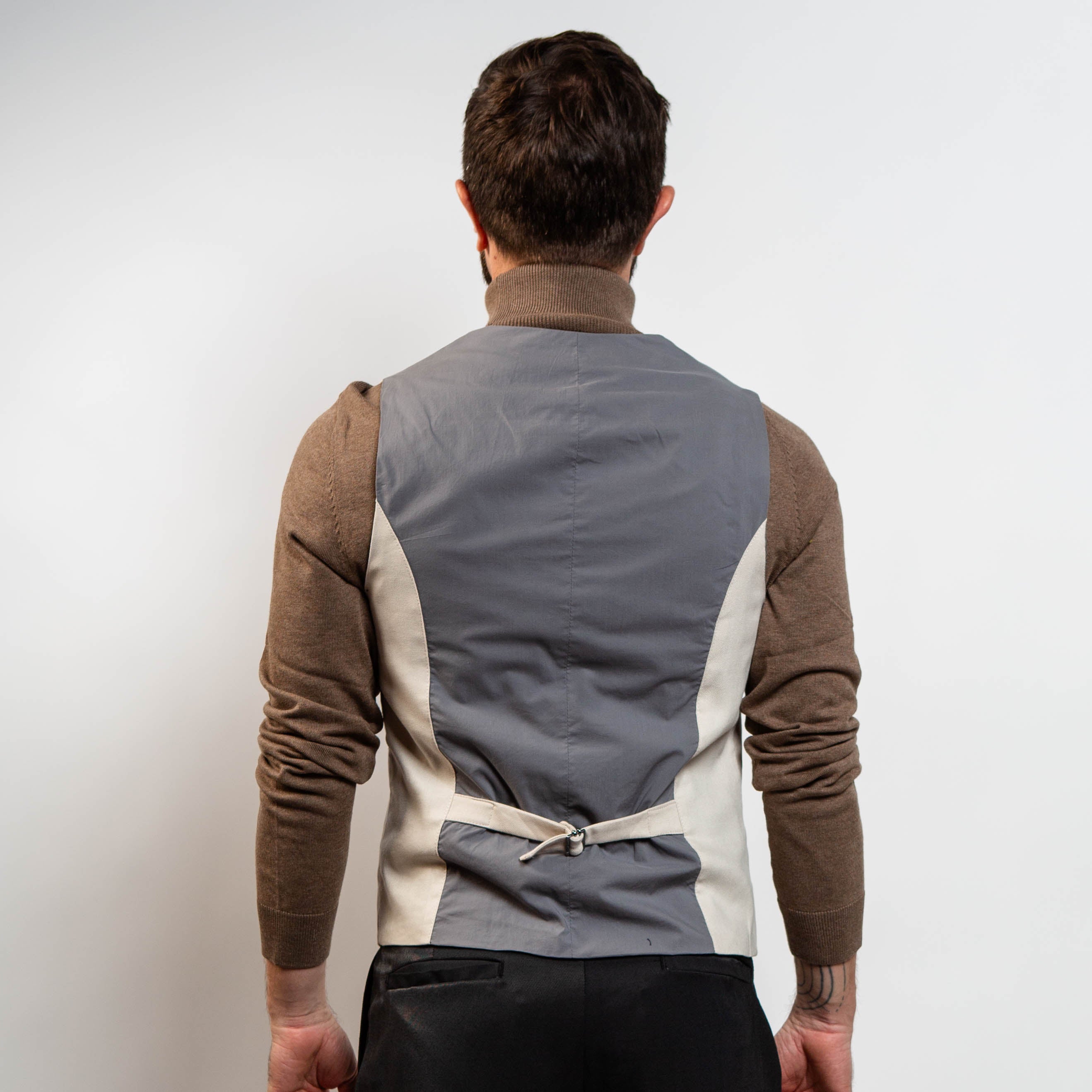 Neutral sand waistcoat styled with brown turtleneck