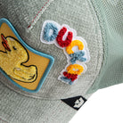 Gray cap with colorful patches including a duck and letters.