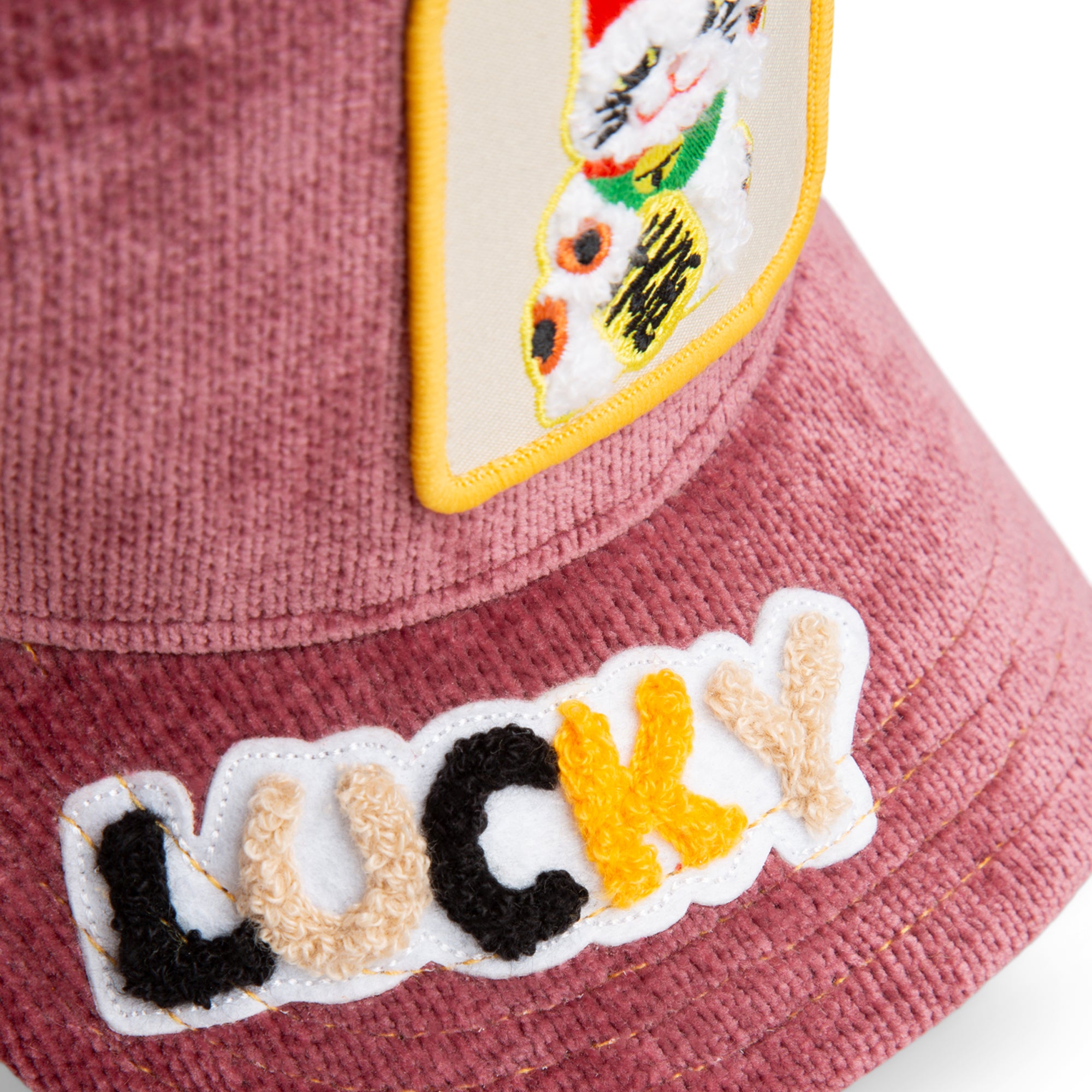 Pink bucket hat with a patch of a cat and the word 'LUCKY'