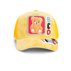 Yellow corduroy Goorin Bros trucker hat with teddy bear patch