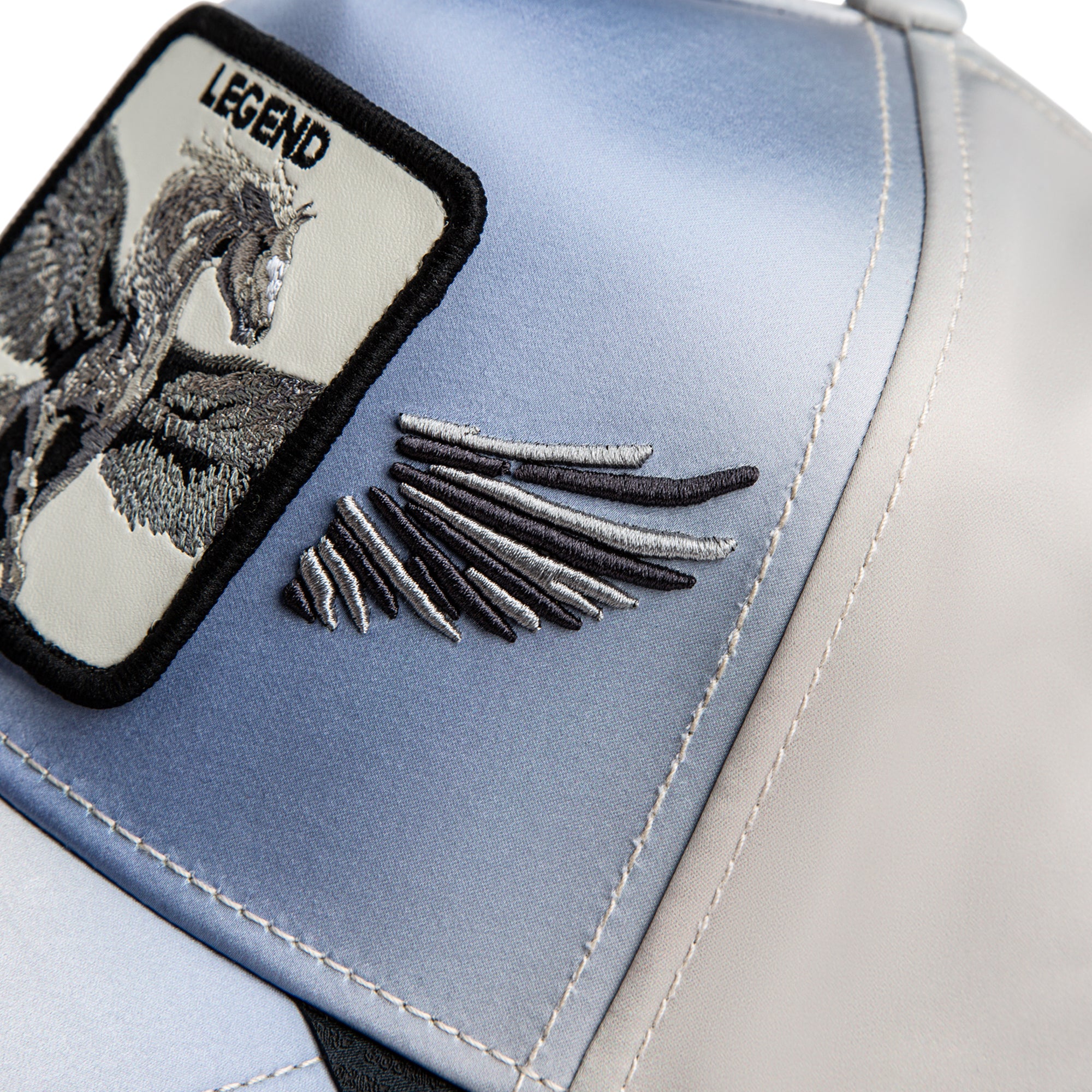 Close-up of a blue and gray bag with an embroidered design and 'Legend' text.