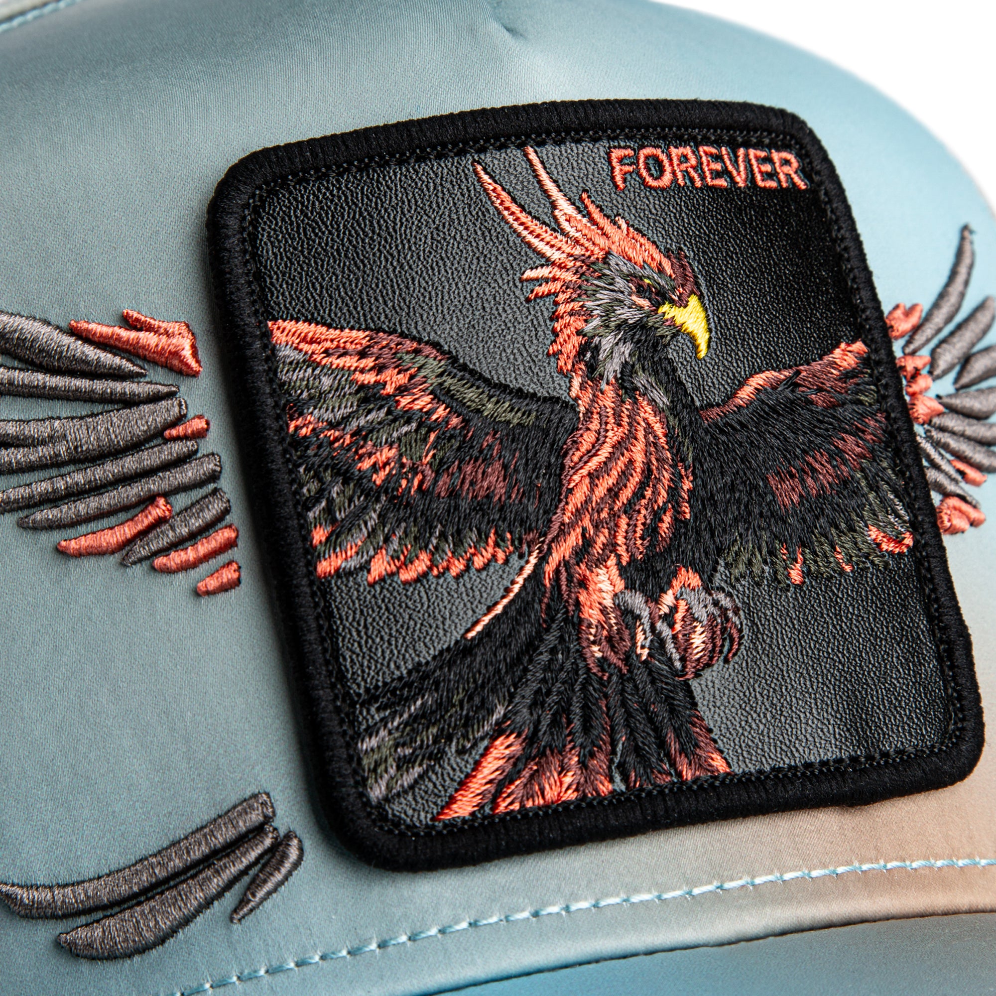 Embroidered patch of an eagle with 'FOREVER' text on a textured surface