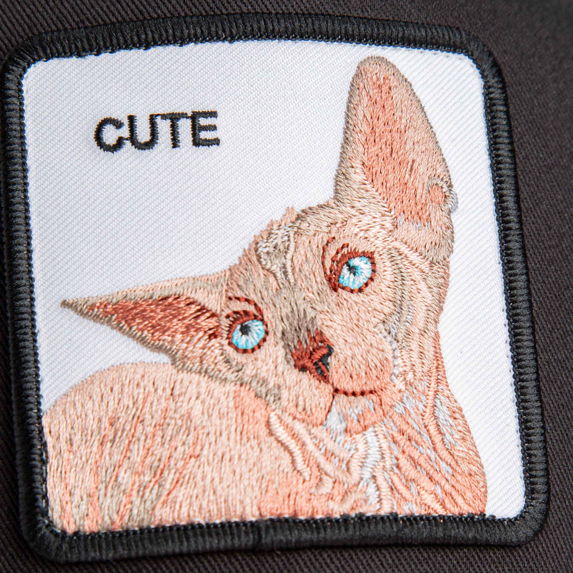 Embroidered patch of a sphynx cat with 'CUTE' text on a white background