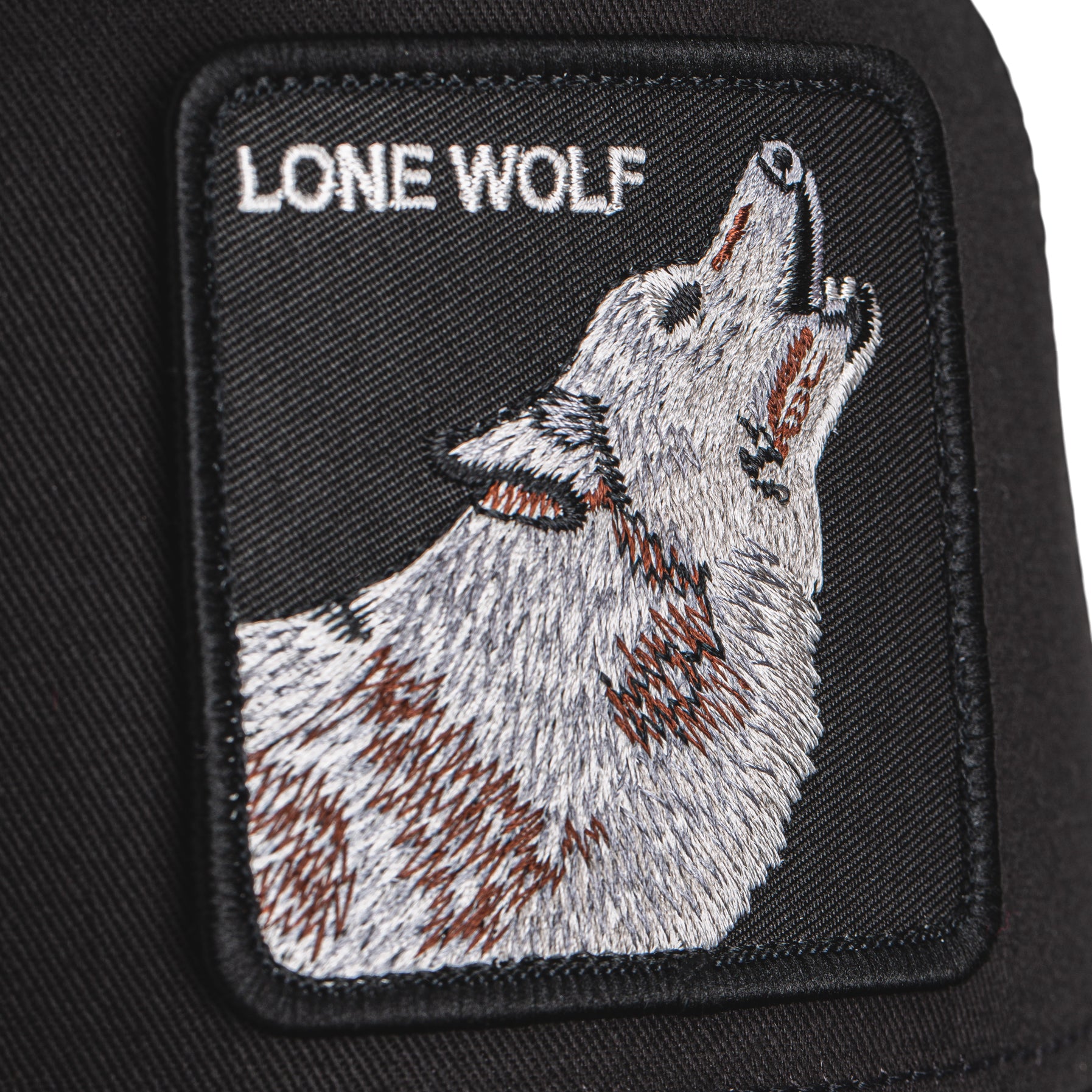 Goorin Bros Lone Wolf Trucker Hat in black with embroidered wolf patch
