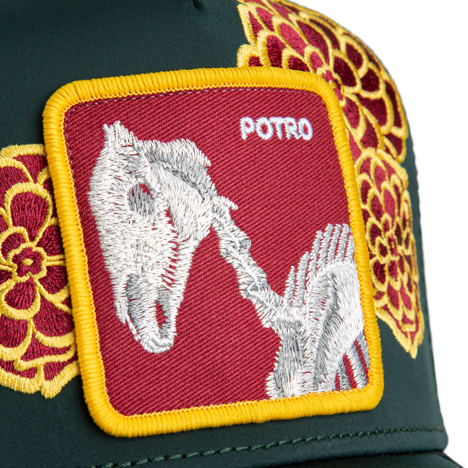 Green trucker hat with floral embroidery and Potro horse patch