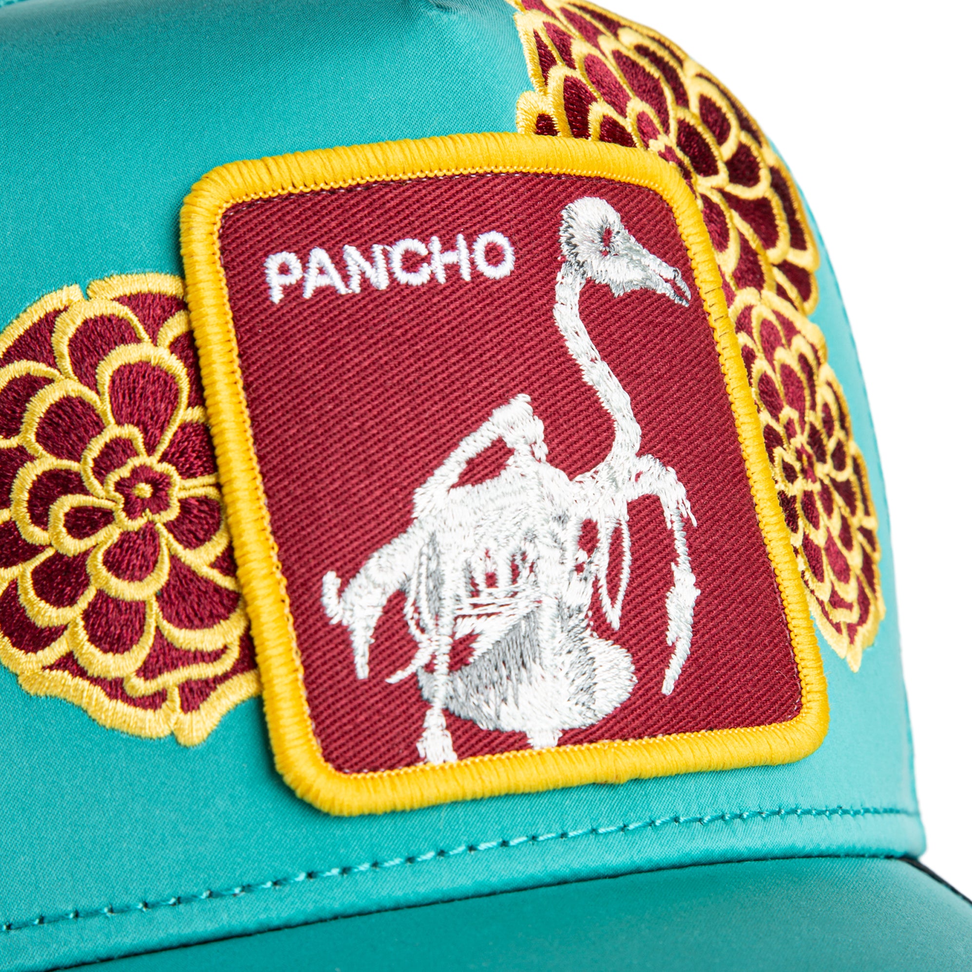 Turquoise trucker hat with floral embroidery and Pancho patch