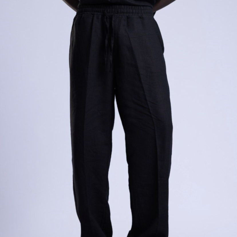 Person wearing a black outfit on a white background
