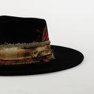 Black fedora hat with a decorative band on a white background
