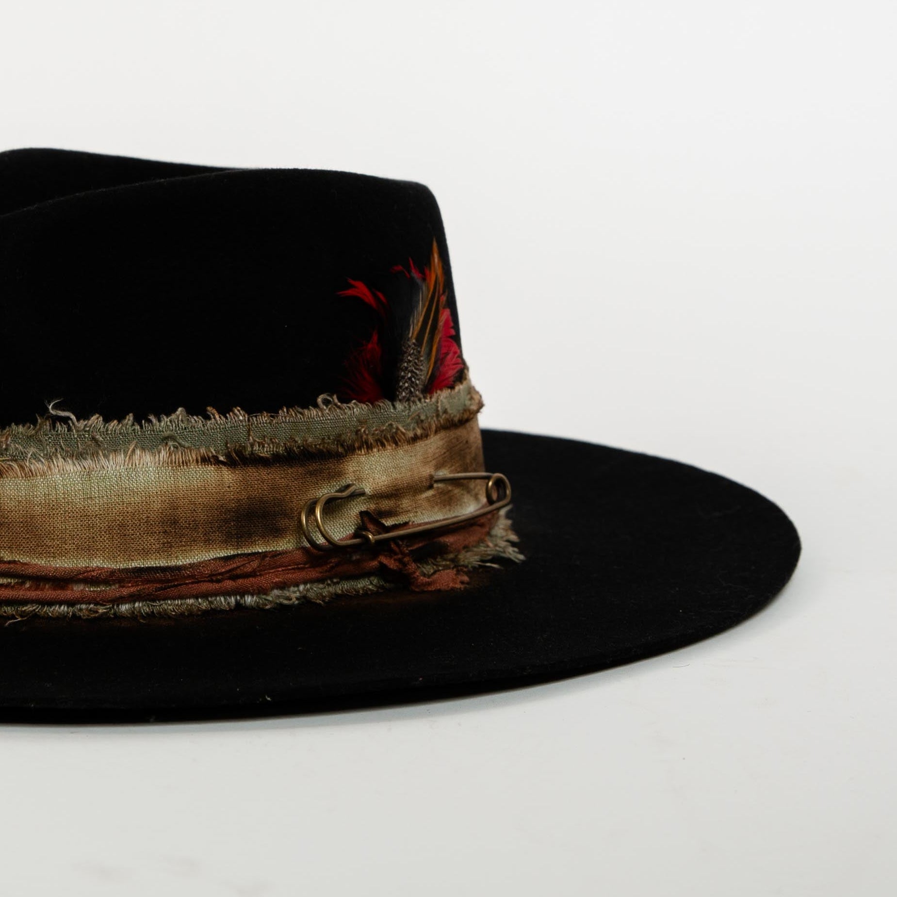 Black fedora hat with a decorative band on a white background