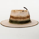 Worn-out fedora hat with a leather band on a white background