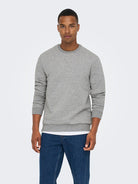 Man wearing a gray sweater and blue jeans on a white background By Only & Sons