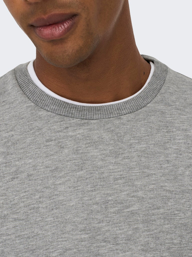 Close-up of a person wearing a gray sweater with a white collar. By Only & Sons