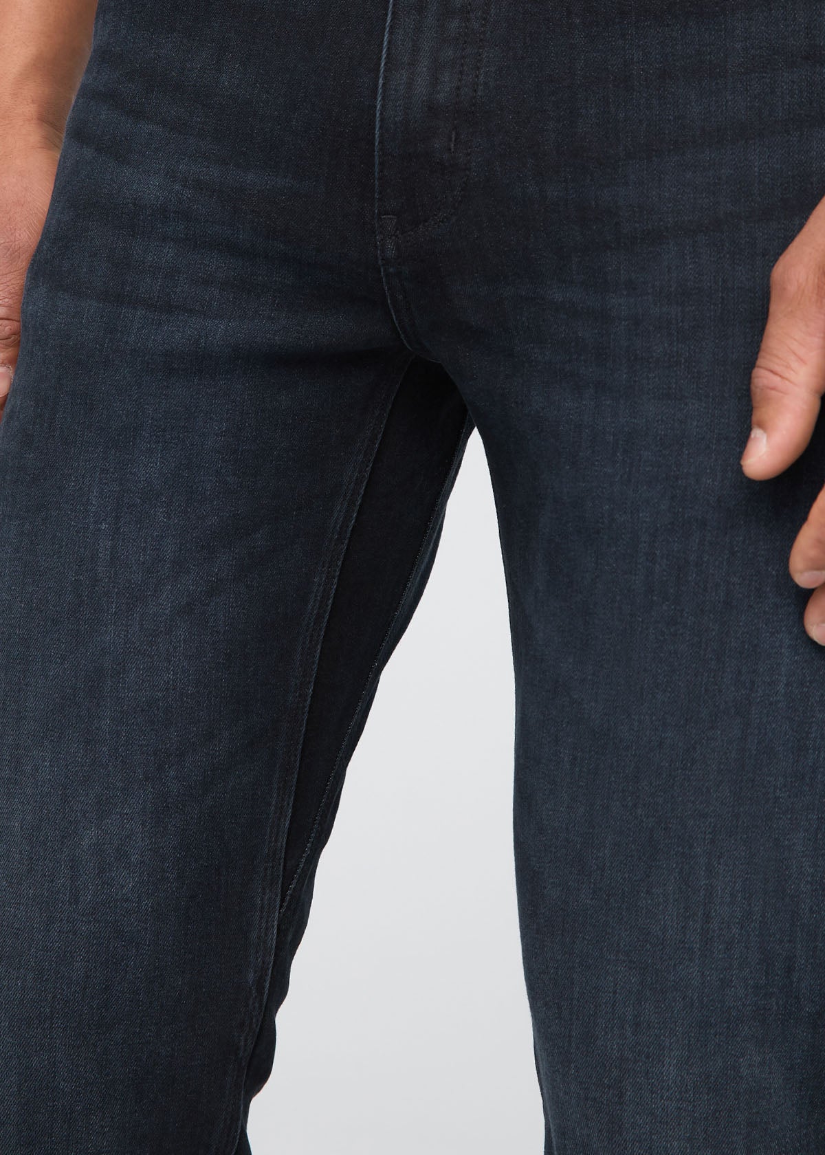Close-up of dark blue jeans on a plain background By Duer Jeans