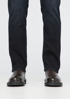 Black jeans worn by a person on a white background By Duer Jeans
