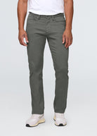 Person wearing gray pants and white sneakers on a white background By Duer Jeans