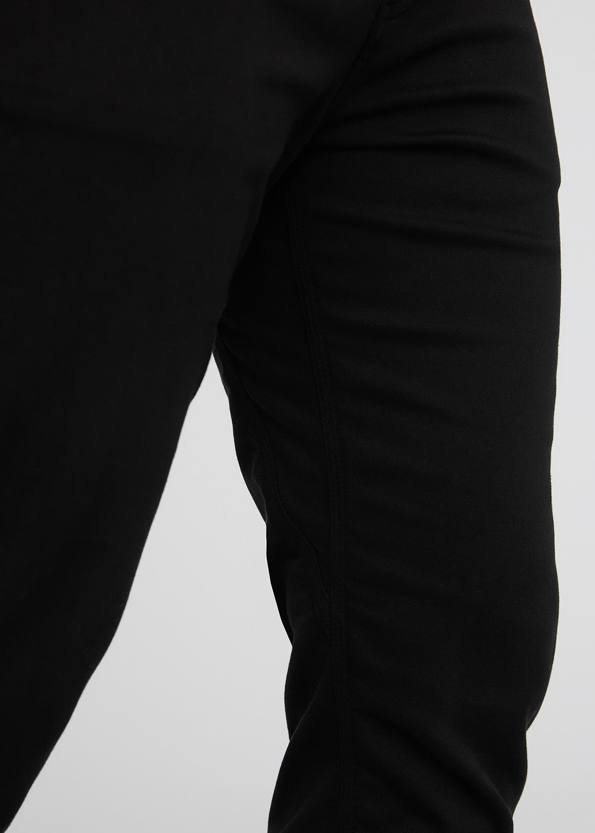 Close-up of a black long-sleeve shirt on a light gray background By Duer Jeans