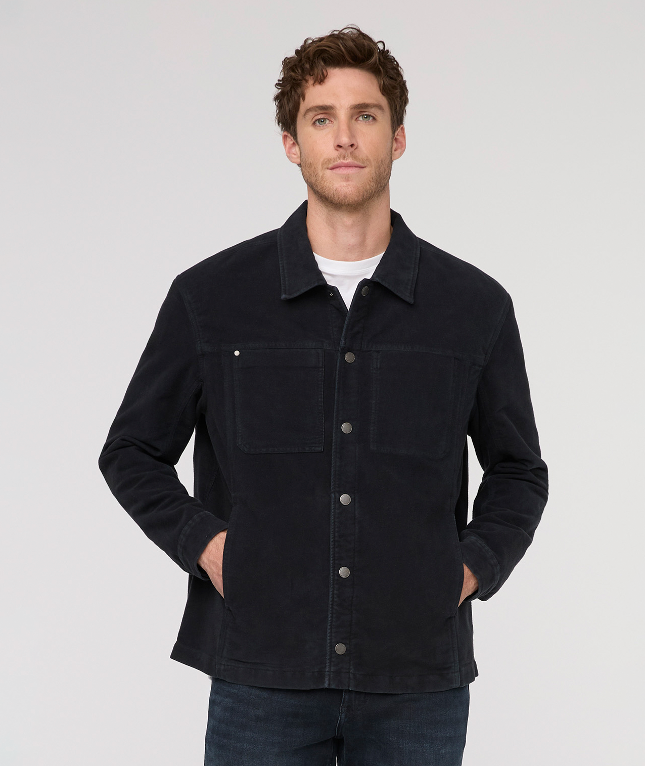 Man wearing a black jacket against a plain background By Duer Jeans