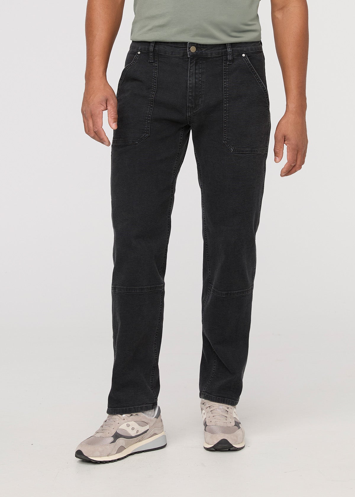 Person wearing black pants on a white background By Duer Jeans