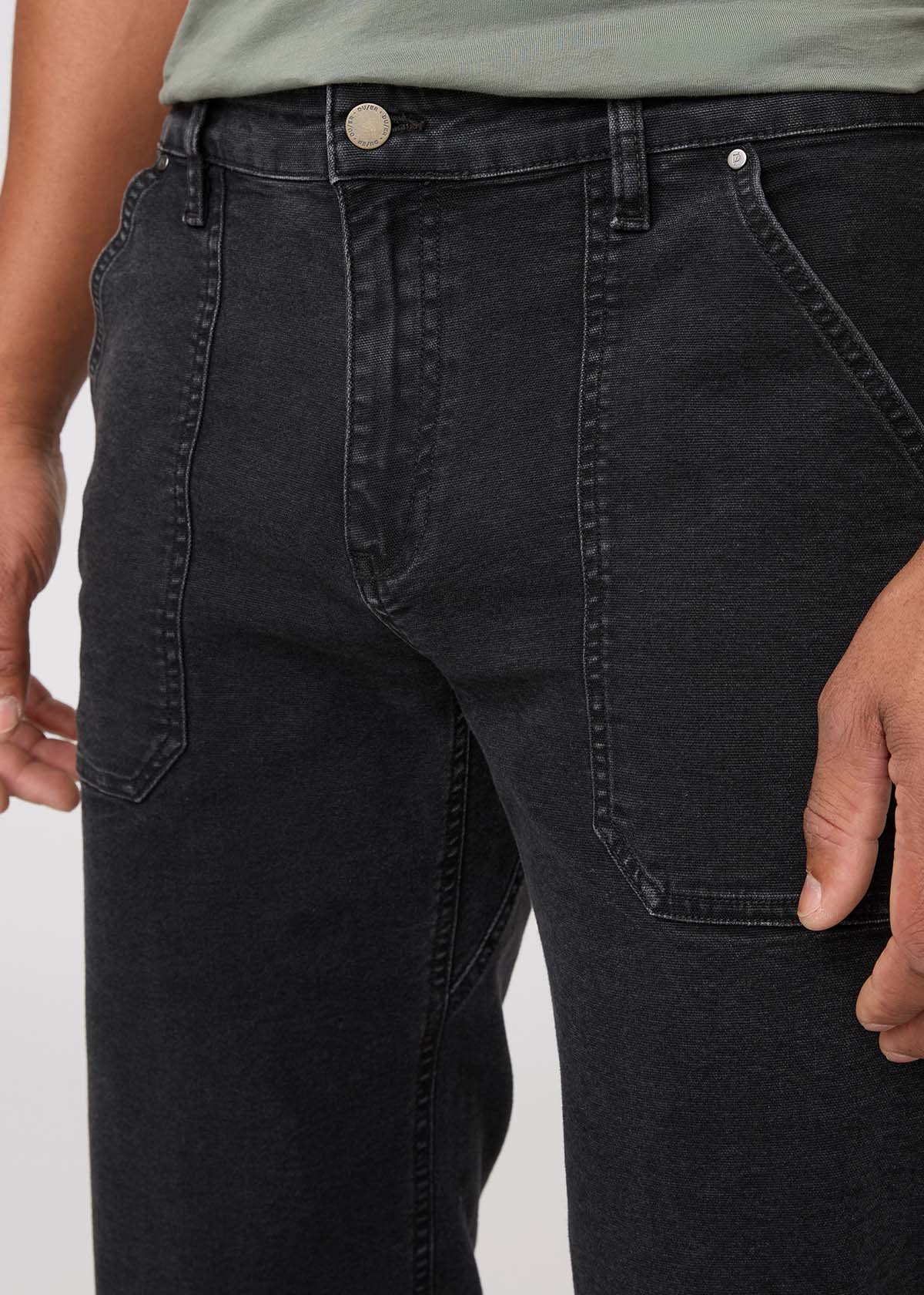 Black jeans worn by a person on a white background By Duer Jeans