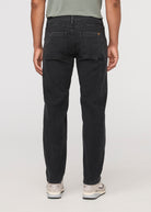 Person wearing black jeans on a white background By Duer Jeans
