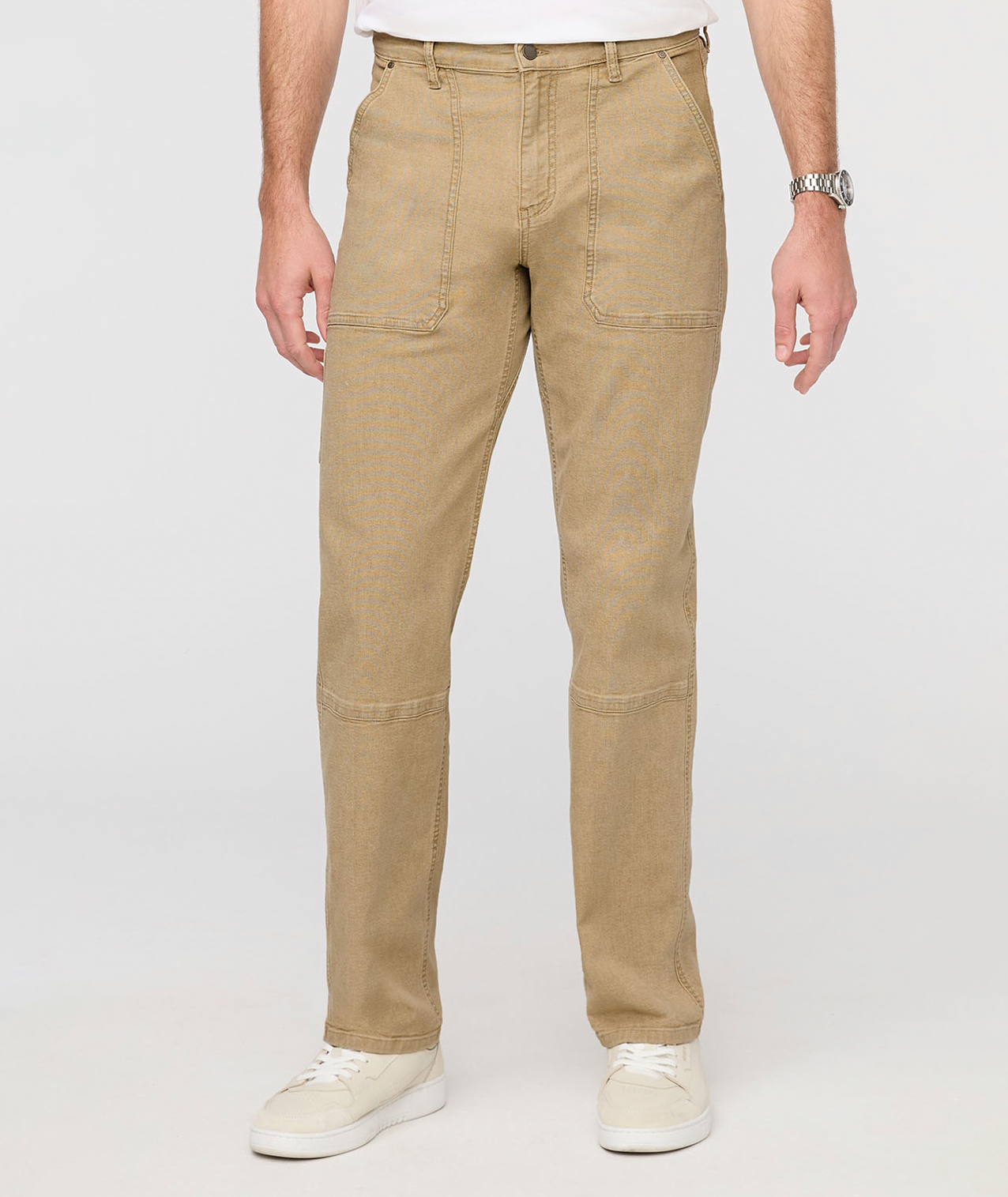 Beige pants worn by a person on a white background By Duer Jeans