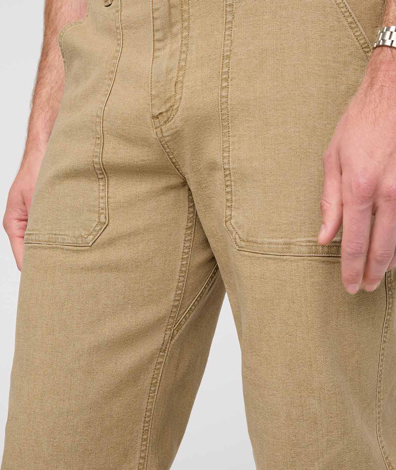 Close-up of beige pants on a plain background By Duer Jeans