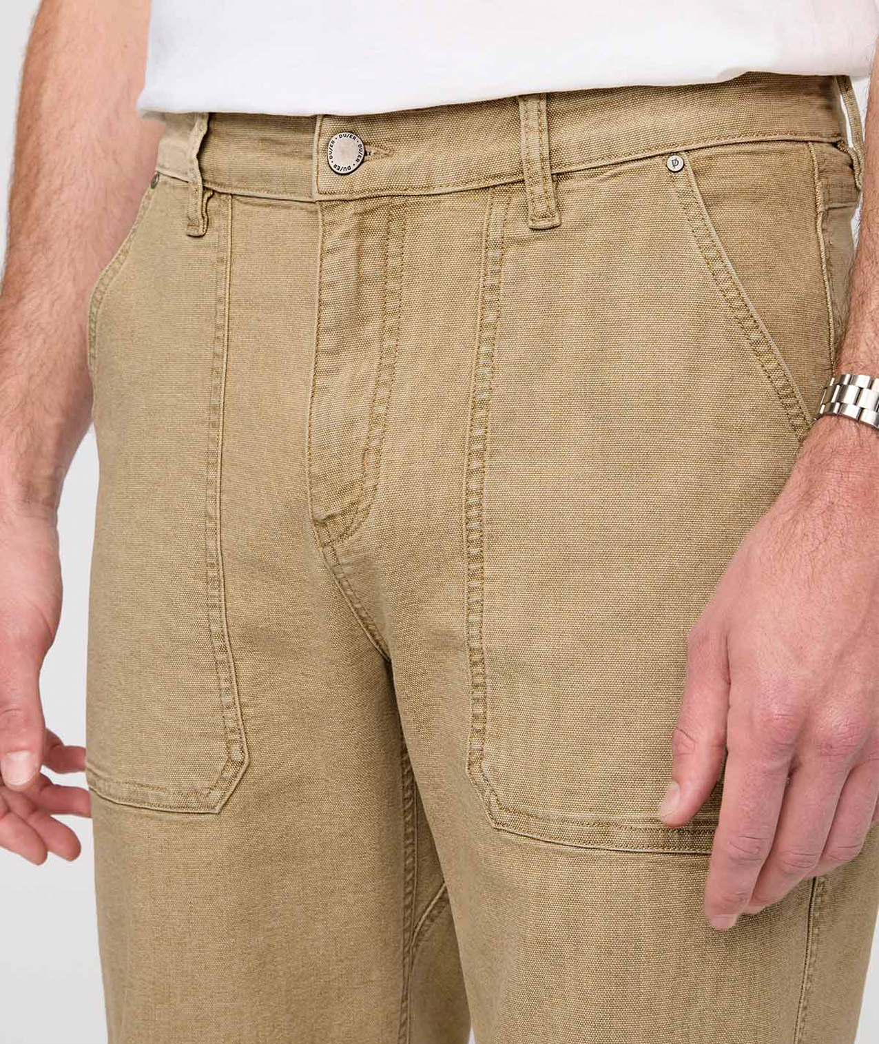 Beige pants worn by a person on a white background By Duer Jeans