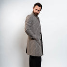 Modern grey wool peacoat layered over brown turtleneck