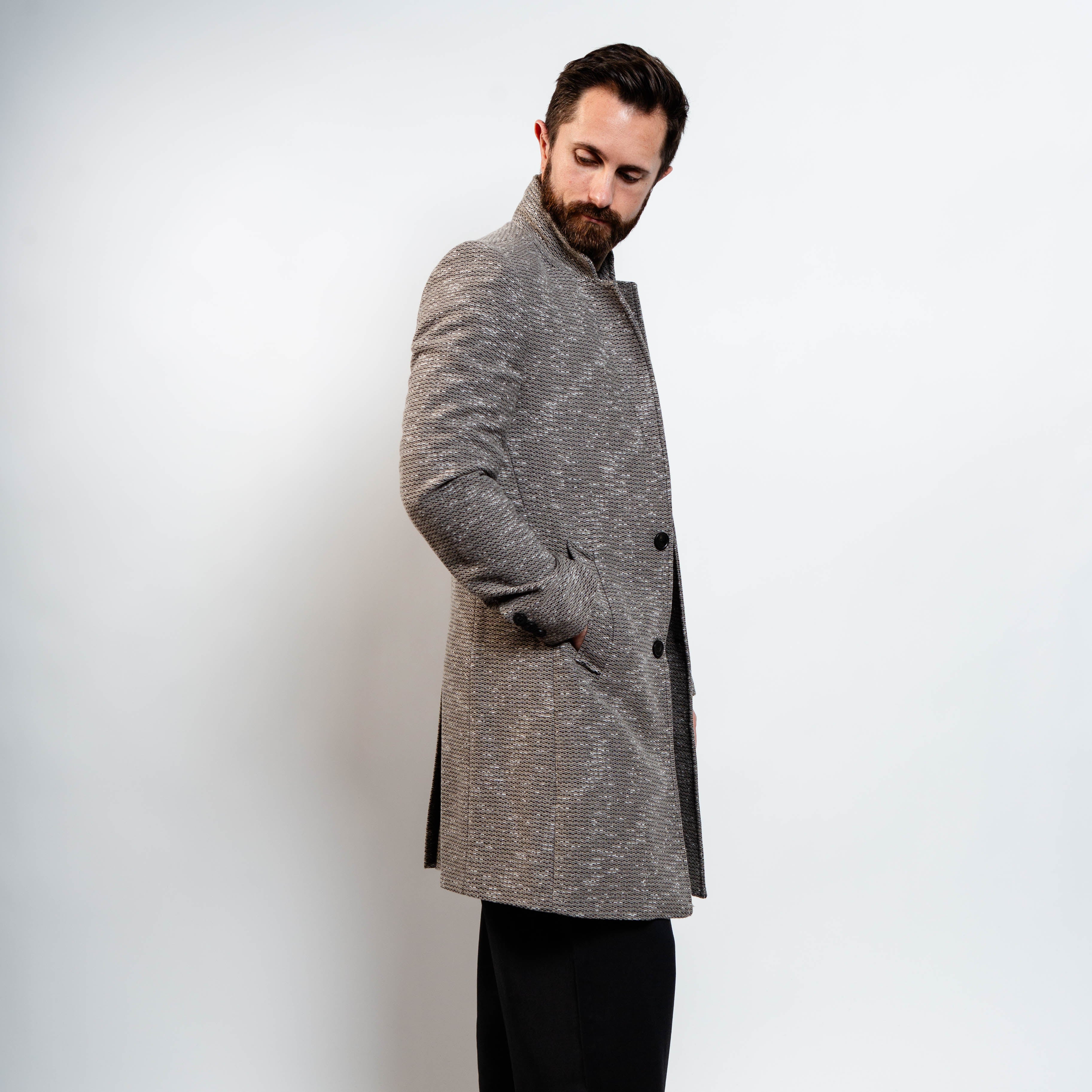 Modern grey wool peacoat layered over brown turtleneck