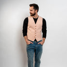 Blush pink waistcoat styled with black sweater