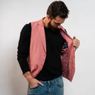 Pink men’s waistcoat styled with black sweater