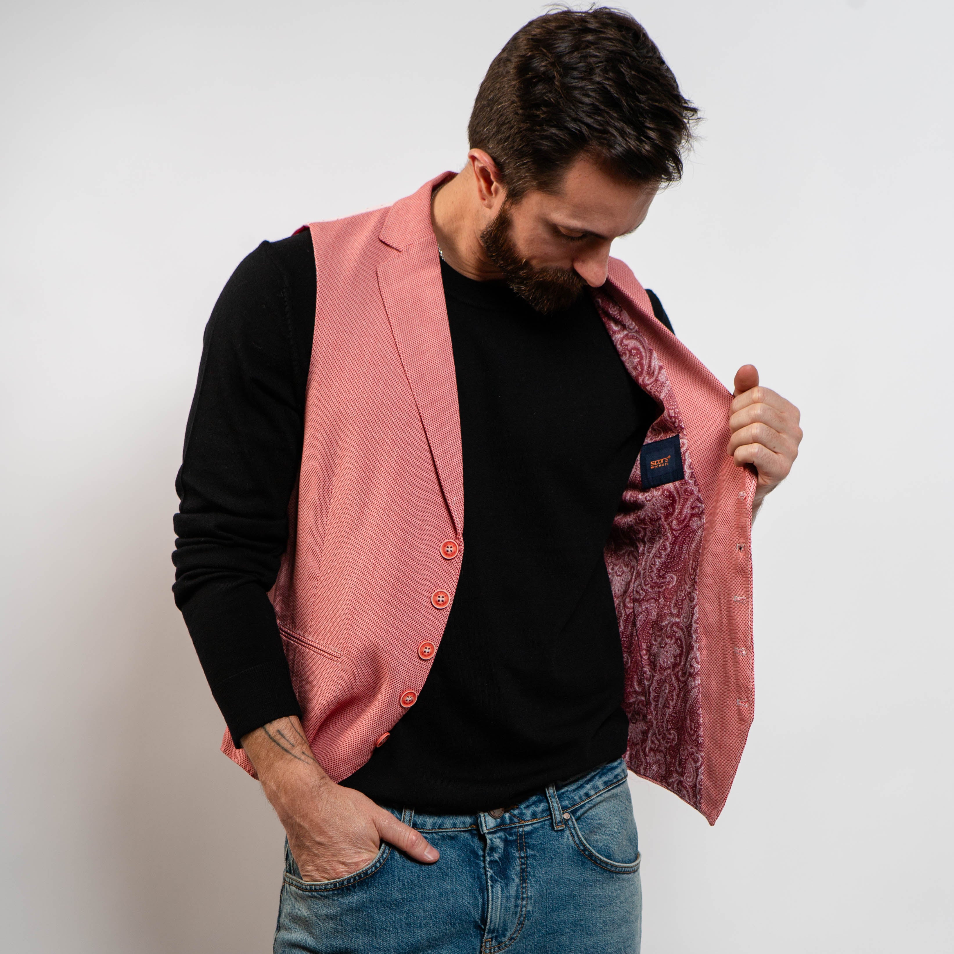Pink men’s waistcoat styled with black sweater