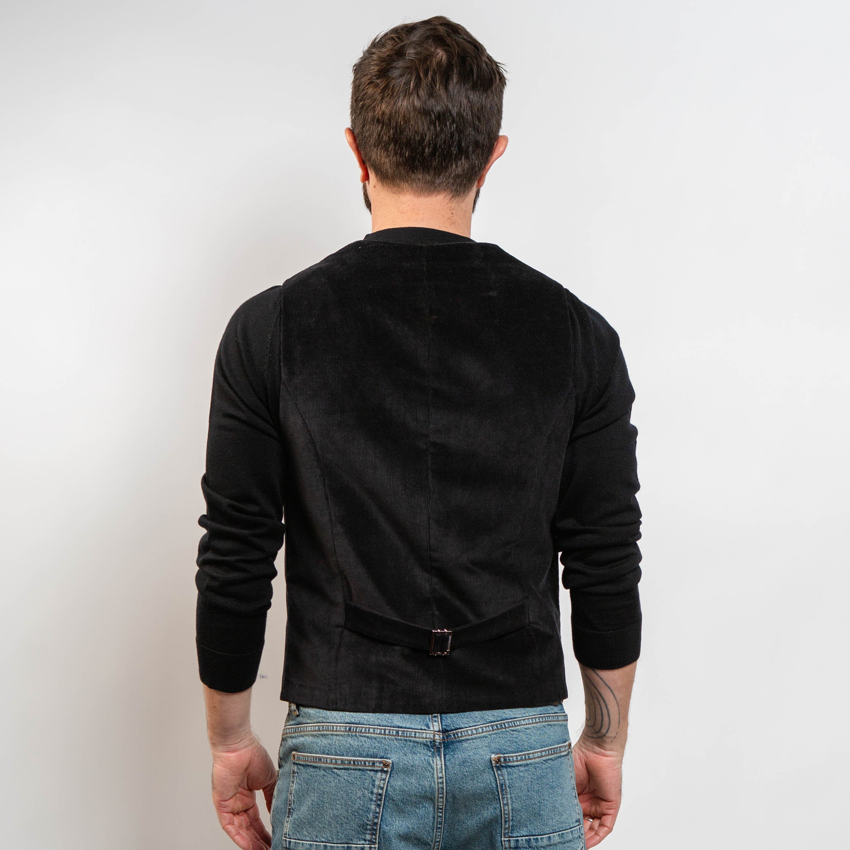 Black corduroy waistcoat styled with black knit