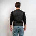 Brown men’s waistcoat styled with jeans and black sweater