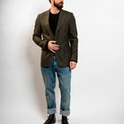 Modern olive blazer styled with jeans